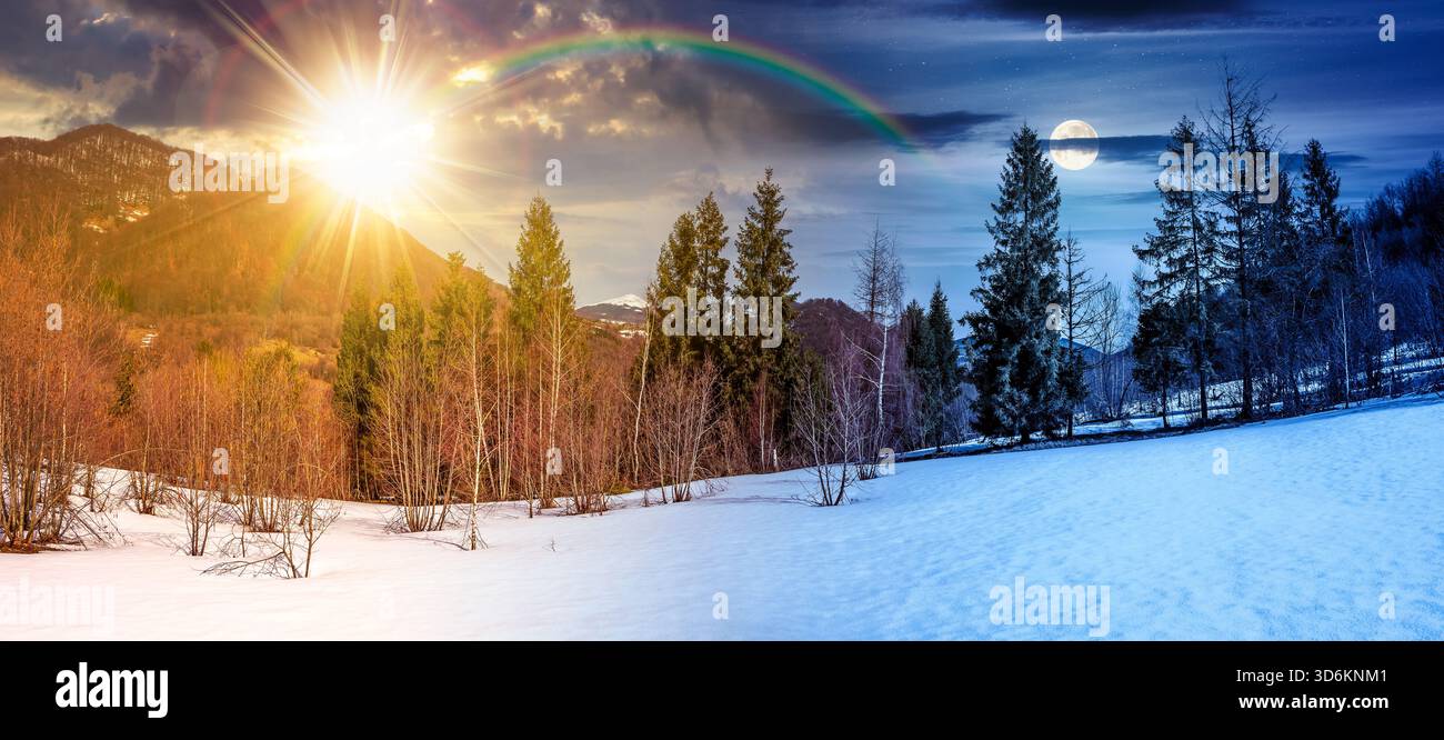 Schneebedeckter Hang mit Wald auf Frühlingsquinox. Tag- und Nachtzeitwechsel. Atemberaubendes Panorama der bergigen Landschaft mit Sonne A Stockfoto