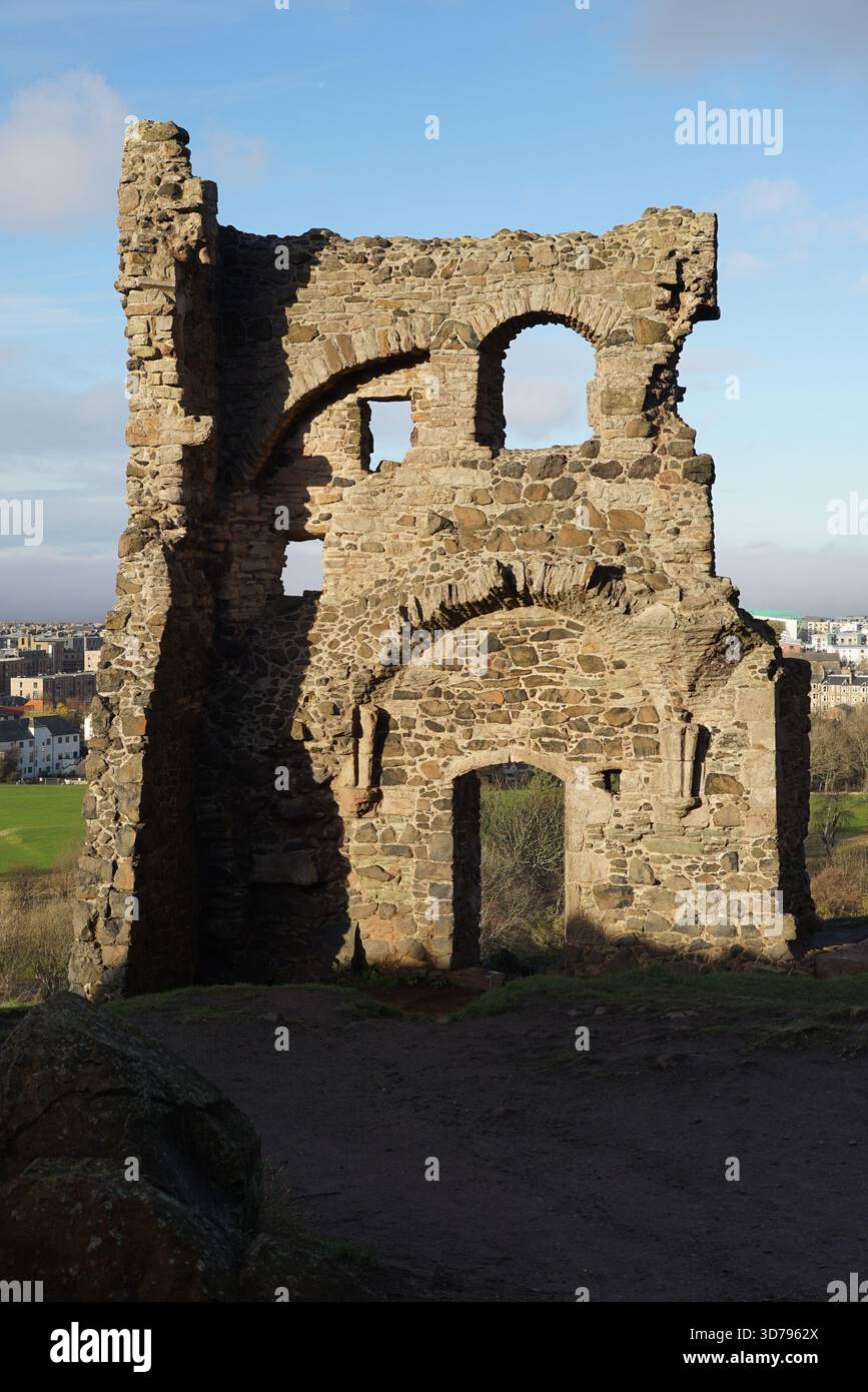 Ruinen der St. Anthony's Chapel im Holyrood Park, Edinburgh, mit Sonnenlicht, das die mittelalterliche Steinstruktur hervorhebt. Edinburgh, Schottland Stockfoto