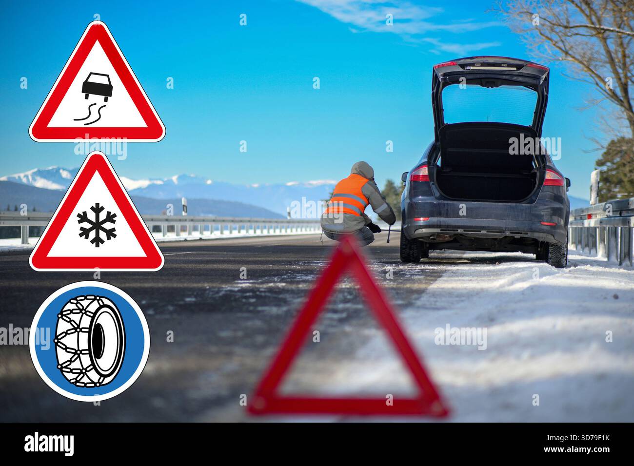 Fahrer mit Blick auf eine Panne auf vereister Winterstraße mit Schnee, Reifenketten und rutschigen Schildern. Stockfoto