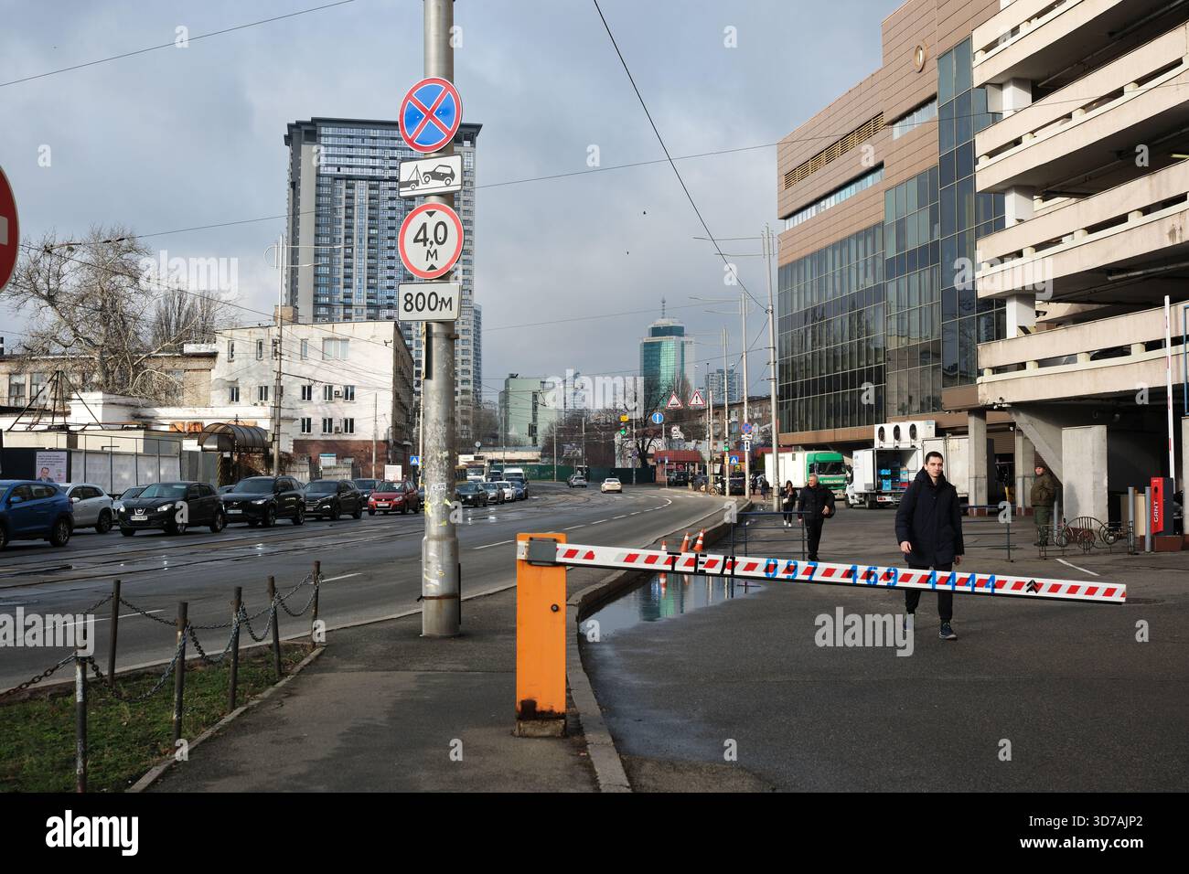 Der Verkehr fließt entlang einer belebten Straße mit Barrieren, die den Zugang verhindern. November 2025 Kiew, Ukraine Stockfoto