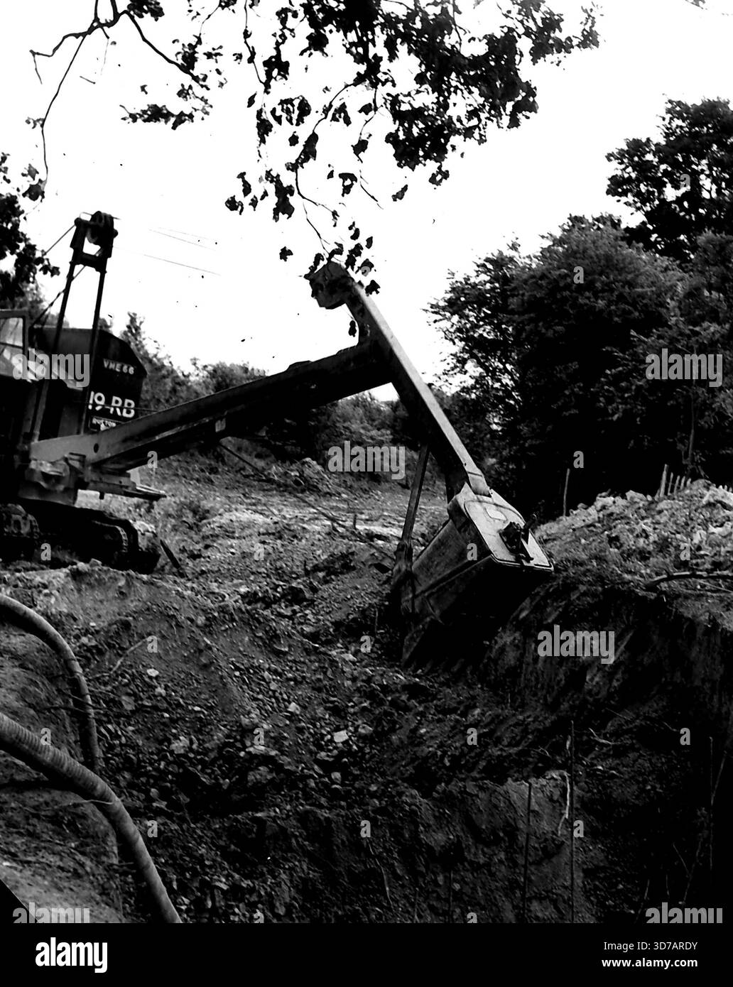 Ein großer Bagger mit Grabenaushubausrüstung nimmt große Bisse aus der Erde, um einen Abflusskanal zu bauen. Dies ist ein Ruston-Bucyrus 19 RB 3/8 Kubikyard-Bagger. Juli 1952. (Foto von Tom Blau, Camera Press). Stockfoto