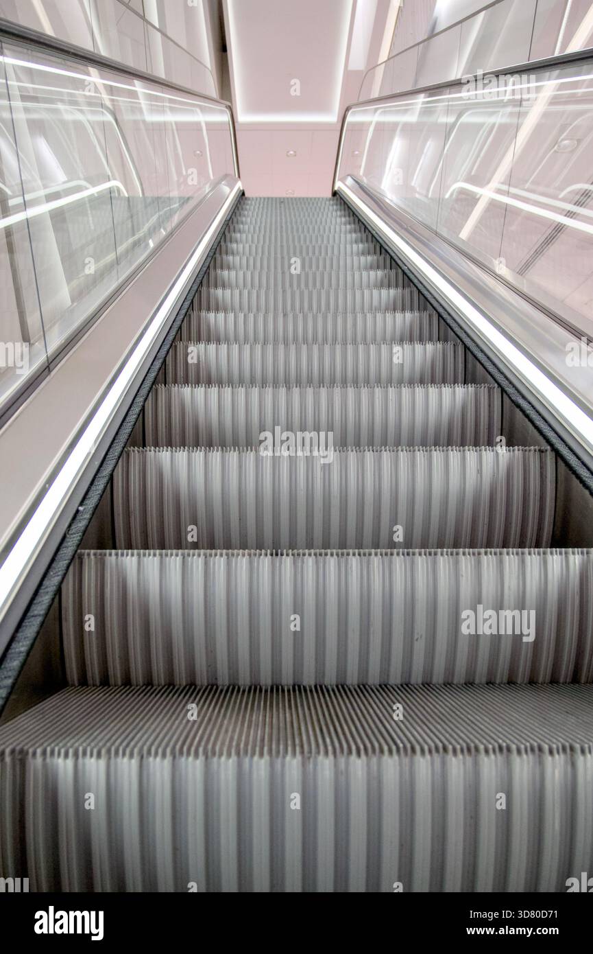 Blick auf eine moderne beleuchtete Rolltreppe in einem Gebäude. Stockfoto