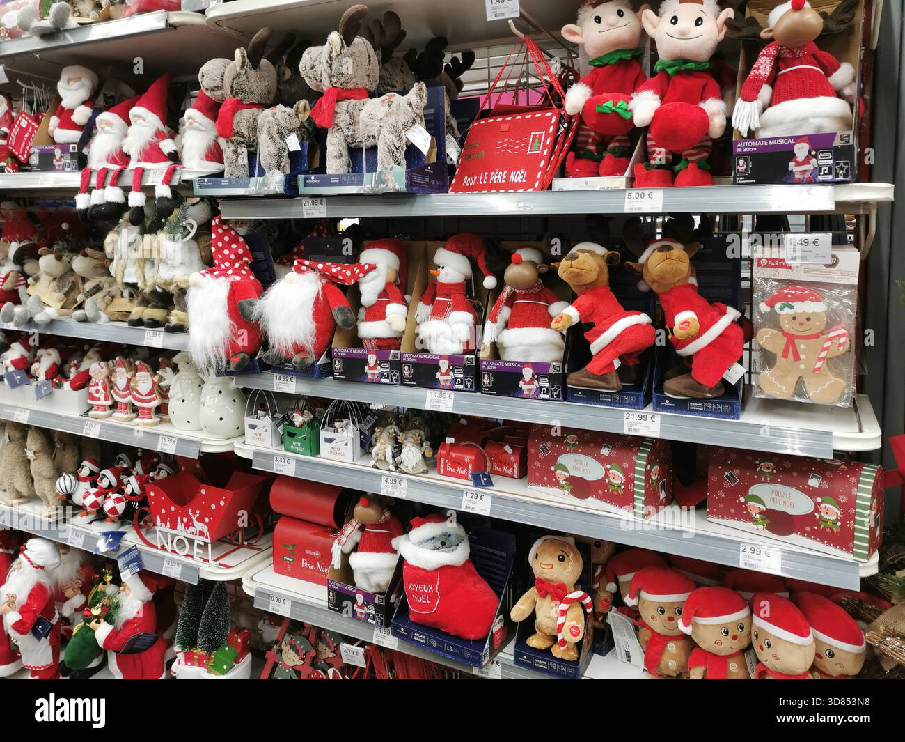 Verschiedene Merchandise im Weihnachtsgeschäft in den Regalen. Gefüllte Weihnachtsmannsfiguren, Rentiere und andere Plüschdekorationen füllen die Regale. Frankreich Stockfoto
