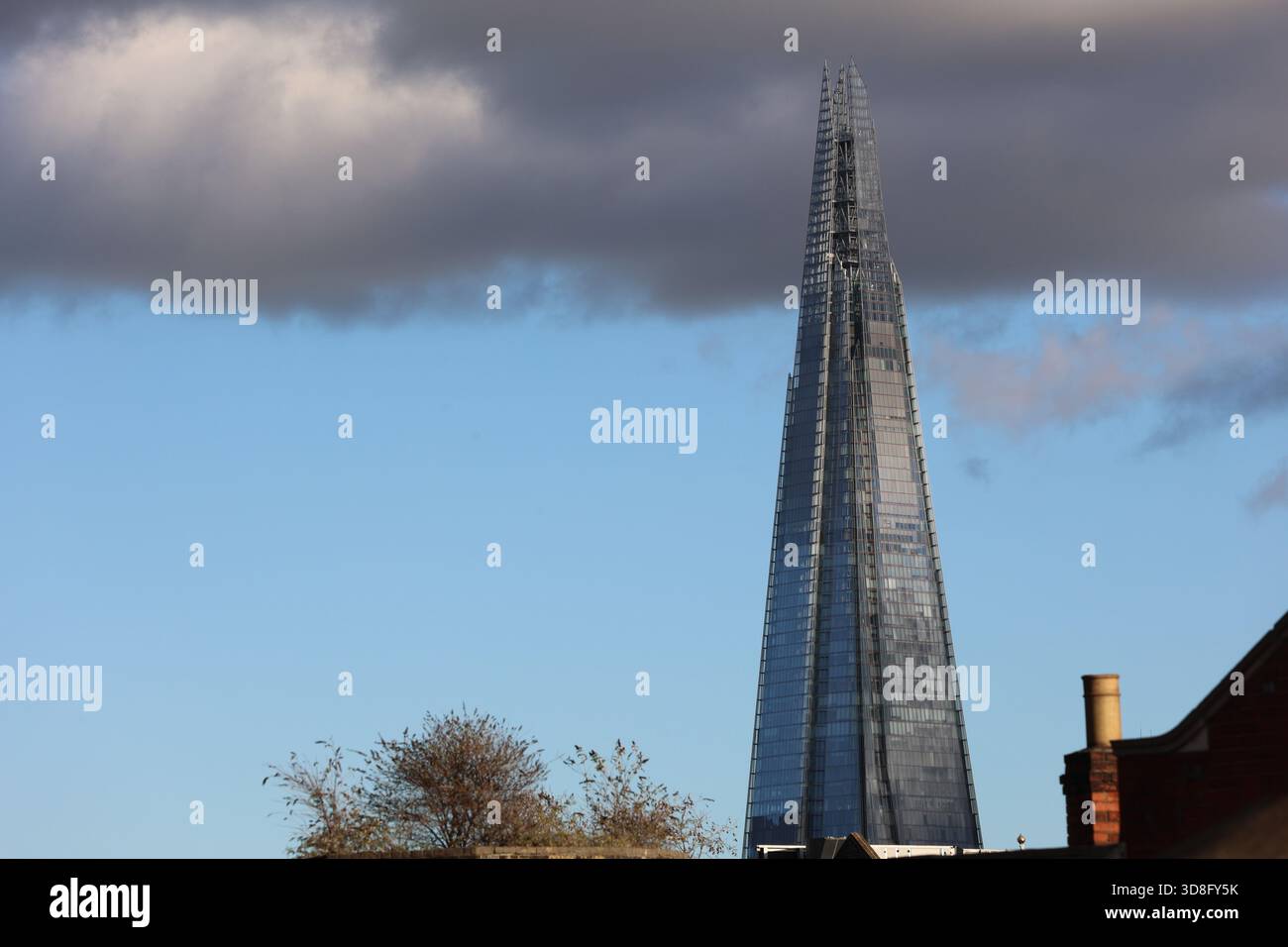 Das Shard London, mit blauem Himmel und dunklen Wolken Stockfoto
