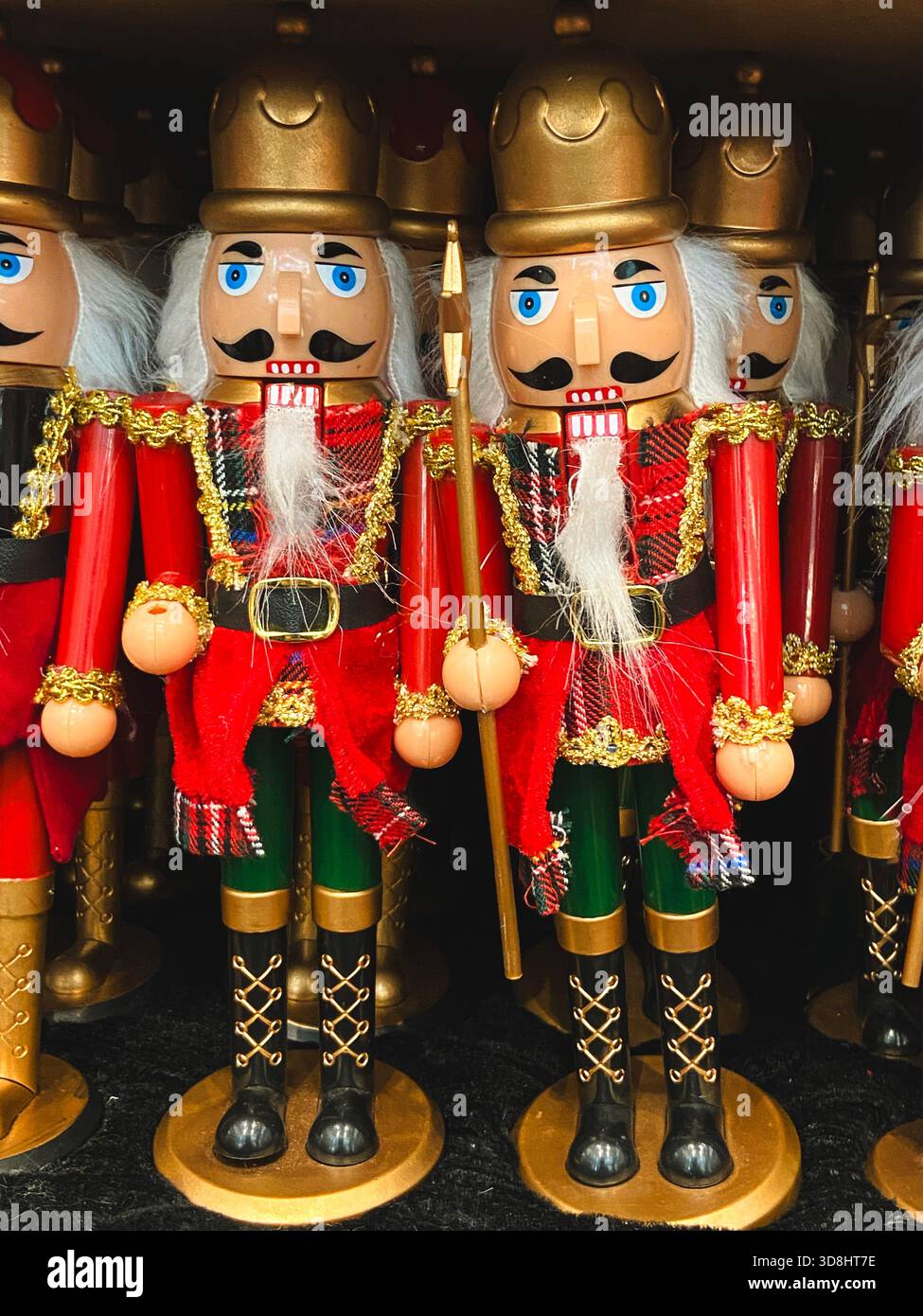 Traditionelle hölzerne Nussknacker-Soldaten in roten und goldenen Uniformen zur Weihnachtsdekoration. Stockfoto