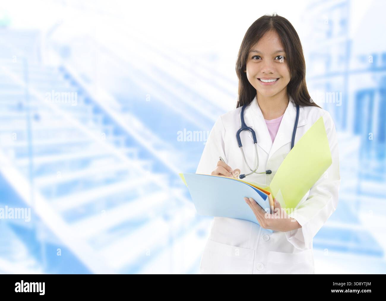 Südostasiatischer Medizinstudent. Junge Ärztin, die auf Krankenhaushintergrund steht Stockfoto