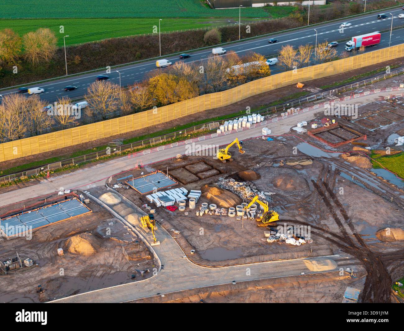 WARRINGTON, CHESHIRE, ENGLAND – 17. NOVEMBER 2025: Akustikzaun zum Schutz von Häusern vor Autobahnlärm, Baustelle für neue Häuser, Warrington Stockfoto