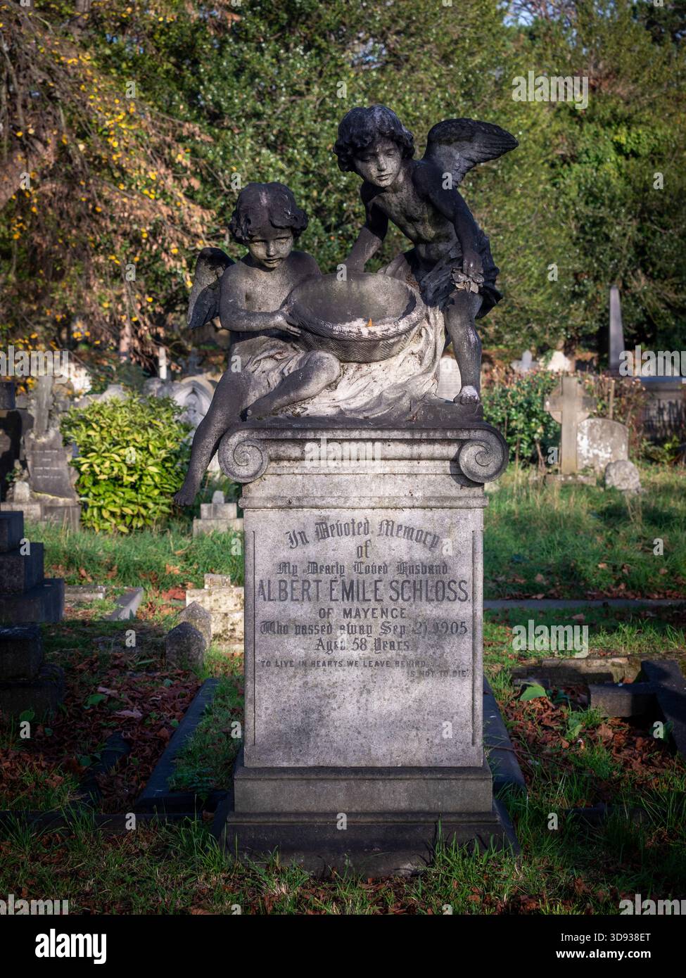 Statue von zwei Cherubs mit einem Korb auf dem viktorianischen Grab von Albert Emile Schloss auf dem Brompton Cemetery. Stockfoto