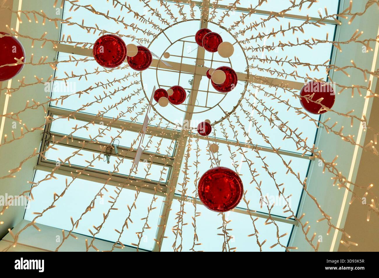 Glasdecke mit roten Kugeln und Girlande im Inneren eines Einkaufszentrums Stockfoto