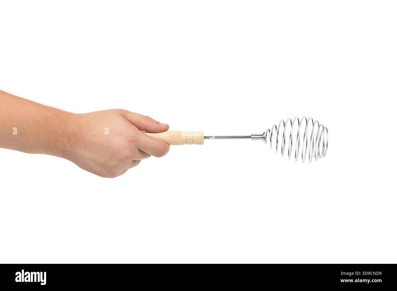Hand hält den Schneebesen aus Edelstahl isoliert auf weißem Hintergrund Stockfoto