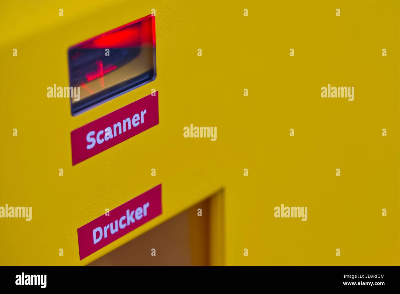 An einer DHL Packstation werden rote Laserscanner und Drucker für Versandetiketten installiert, um Pakete zu scannen oder sie mit Versandetiketten zu versehen Stockfoto