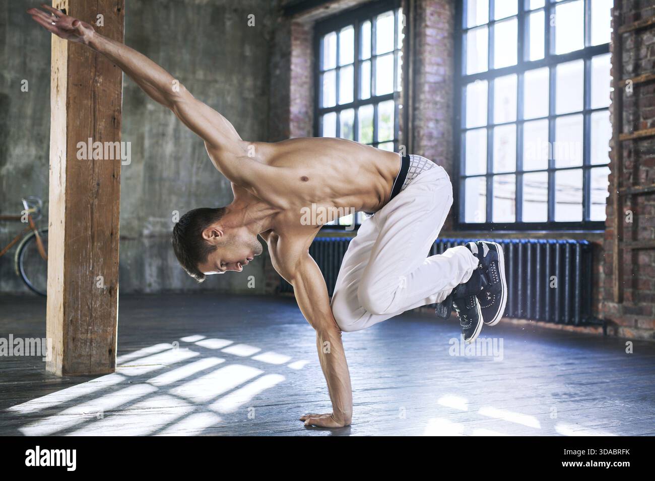 Junger Mann Breakdance in alten sonnigen städtische Interieur Stockfoto