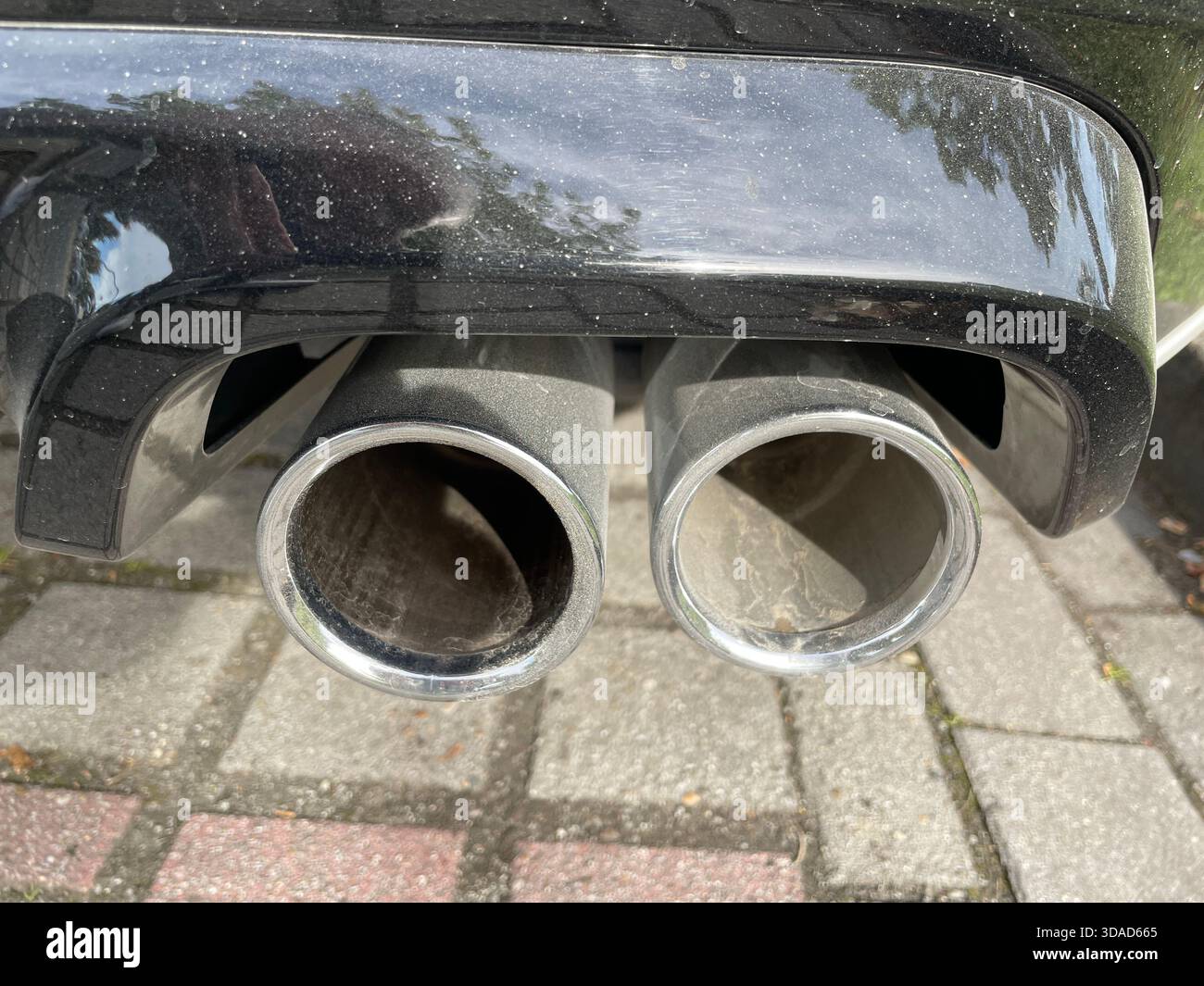Ende eines doppelten Auspuffrohrs eines Autos Stockfoto