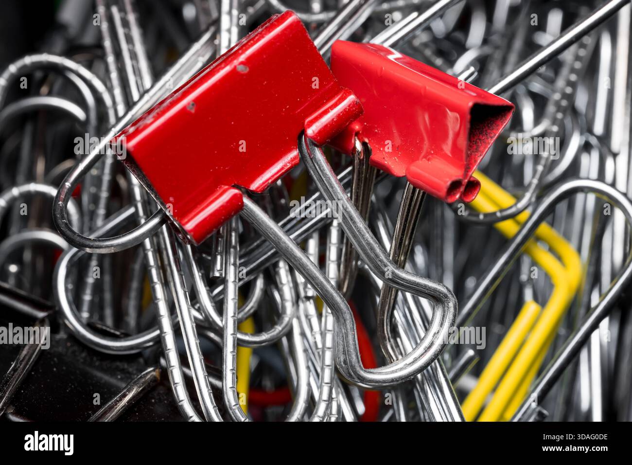 Zwei rote Federclips an den vielen Metallclips aus der Nahansicht. Stockfoto