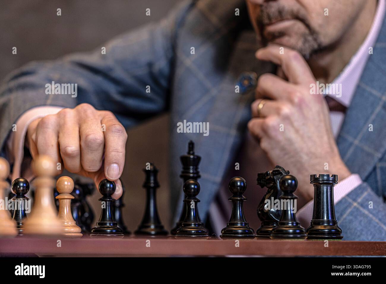 Männliche Hand bewegte Schachstück an Bord, Nahaufnahme Stockfoto