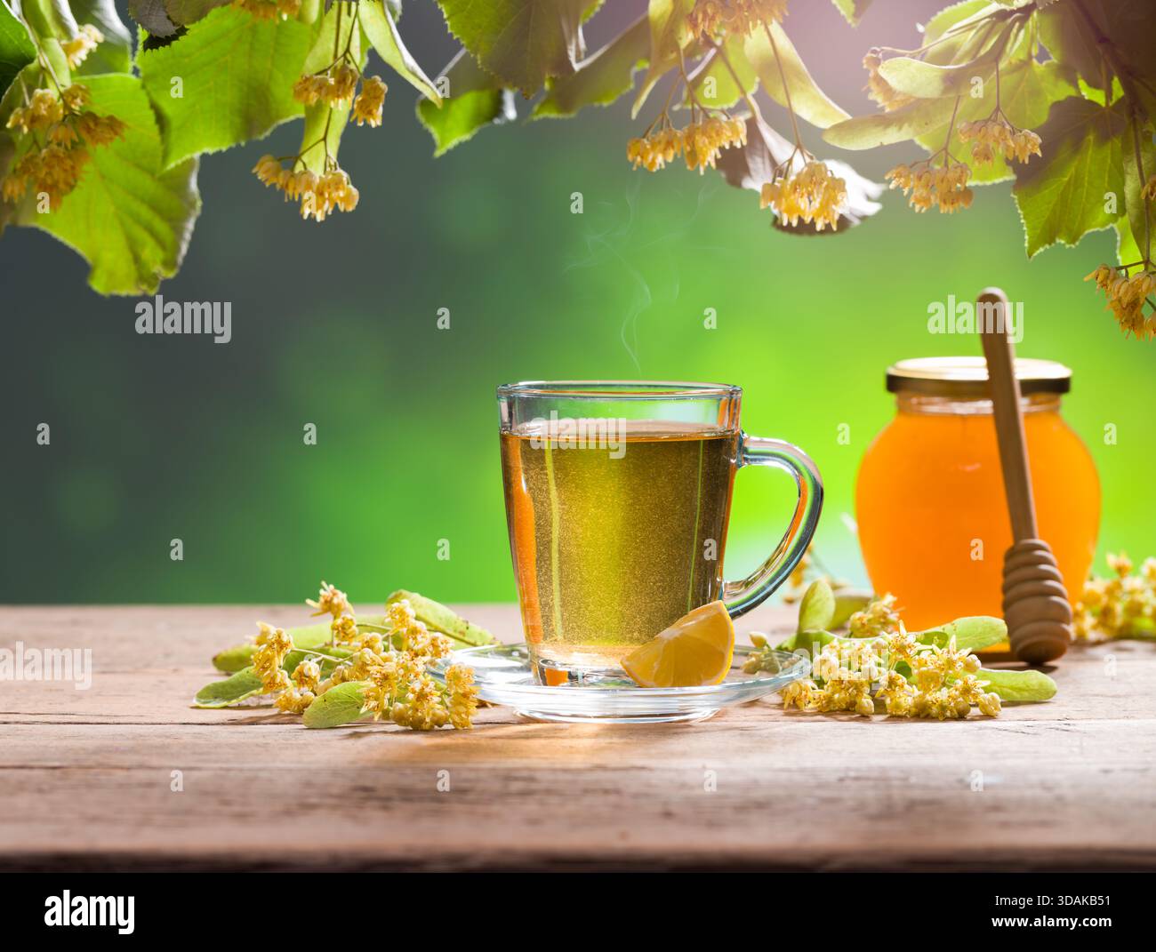 Ein Glas Lindentee. Lindenblumen und Honig im Hintergrund Stockfoto