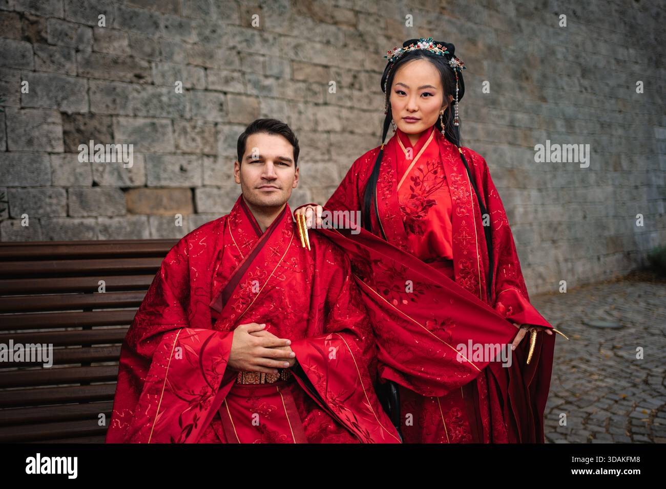 Interkulturelles Paar feiert traditionelle chinesische Hochzeitszeremonie Stockfoto