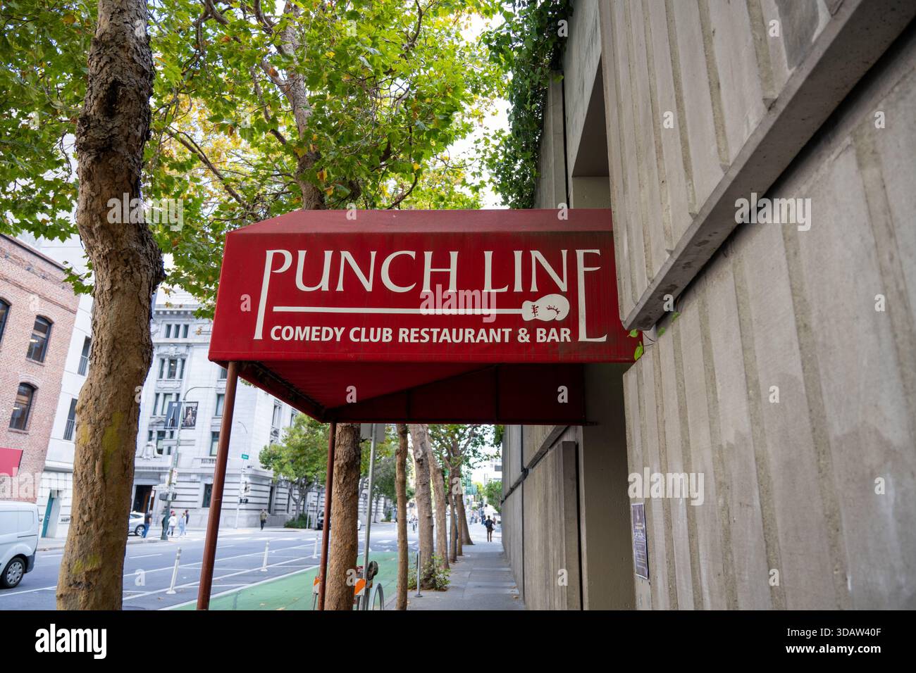 Rote Markise mit Punch Line Comedy Club Restaurant & Bar-Schild am baumgesäumten Bürgersteig, San Francisco, Kalifornien, 14. August 2025. (Foto: Smith Collection/Gado/SIPA USA) Stockfoto