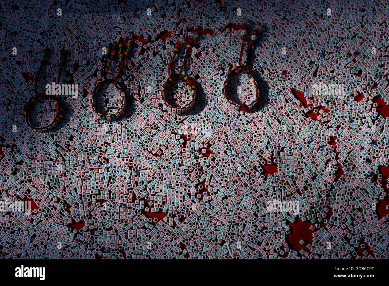 Handgefertigte Ritualarmbänder auf einer Oberfläche mit symbolischen Buchstabenketten auf einem traditionellen Markt in Nepal. Stockfoto