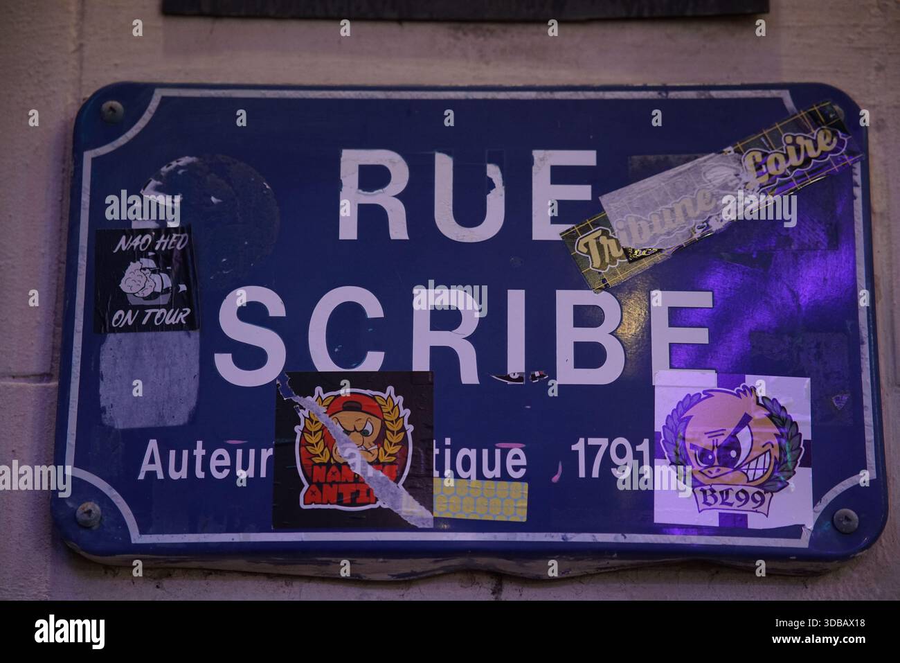 Blaues Straßenschild der Rue Scribe mit Aufklebern an einer Wand im Stadtzentrum von Nantes, Frankreich. Nantes, Frankreich Stockfoto