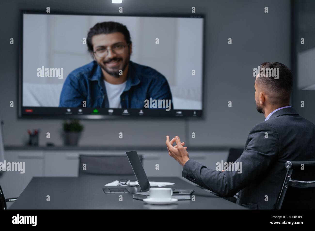 Geschäftstreffen, die per Videoanruf zwischen zwei Fachleuten in einer Büroumgebung durchgeführt werden Stockfoto
