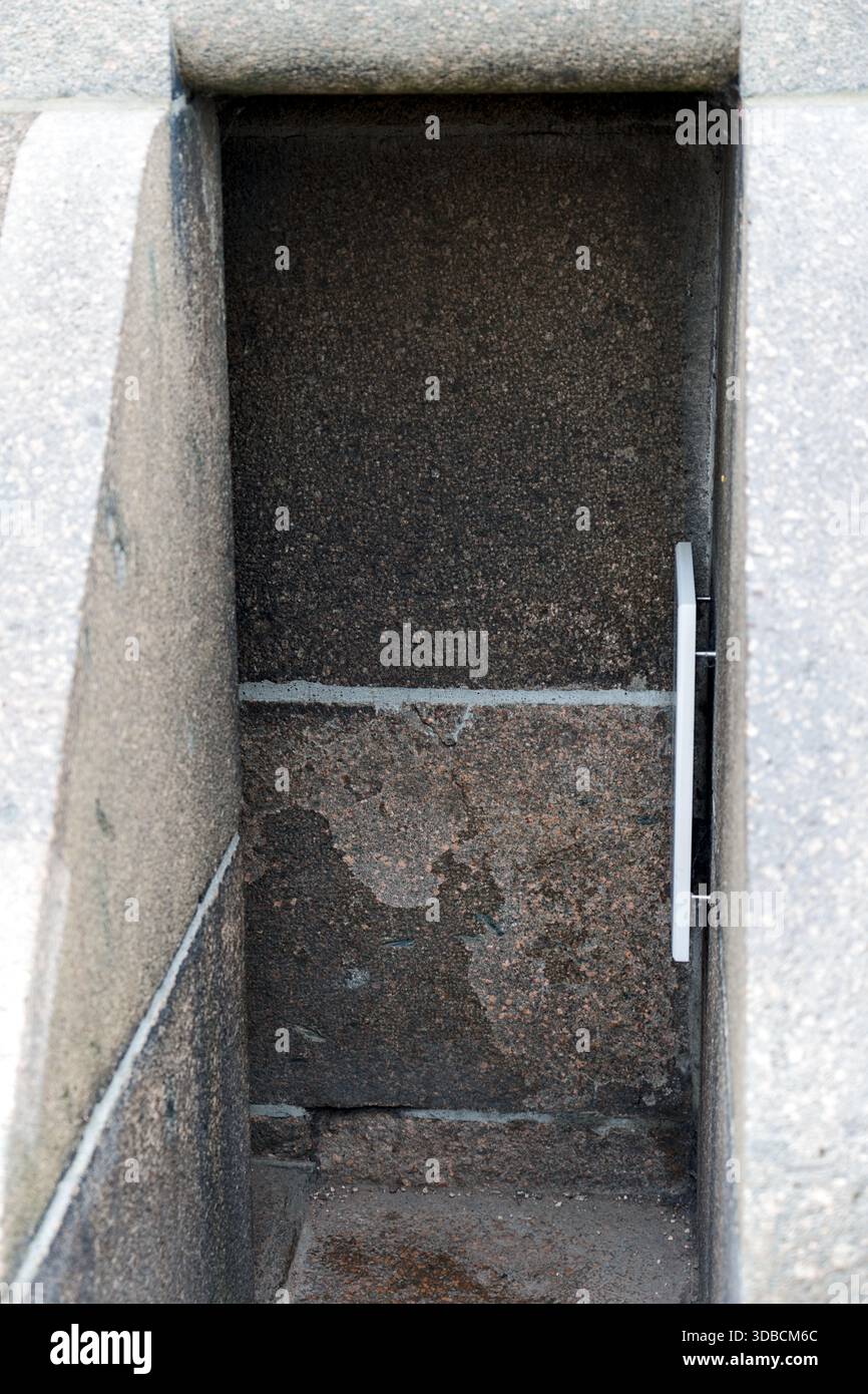 Ein enger Treppenaufgang mit dunklem Innenraum, der ein Gefühl von Tiefe und Geheimnis in einem engen architektonischen Raum vermittelt. Stockfoto