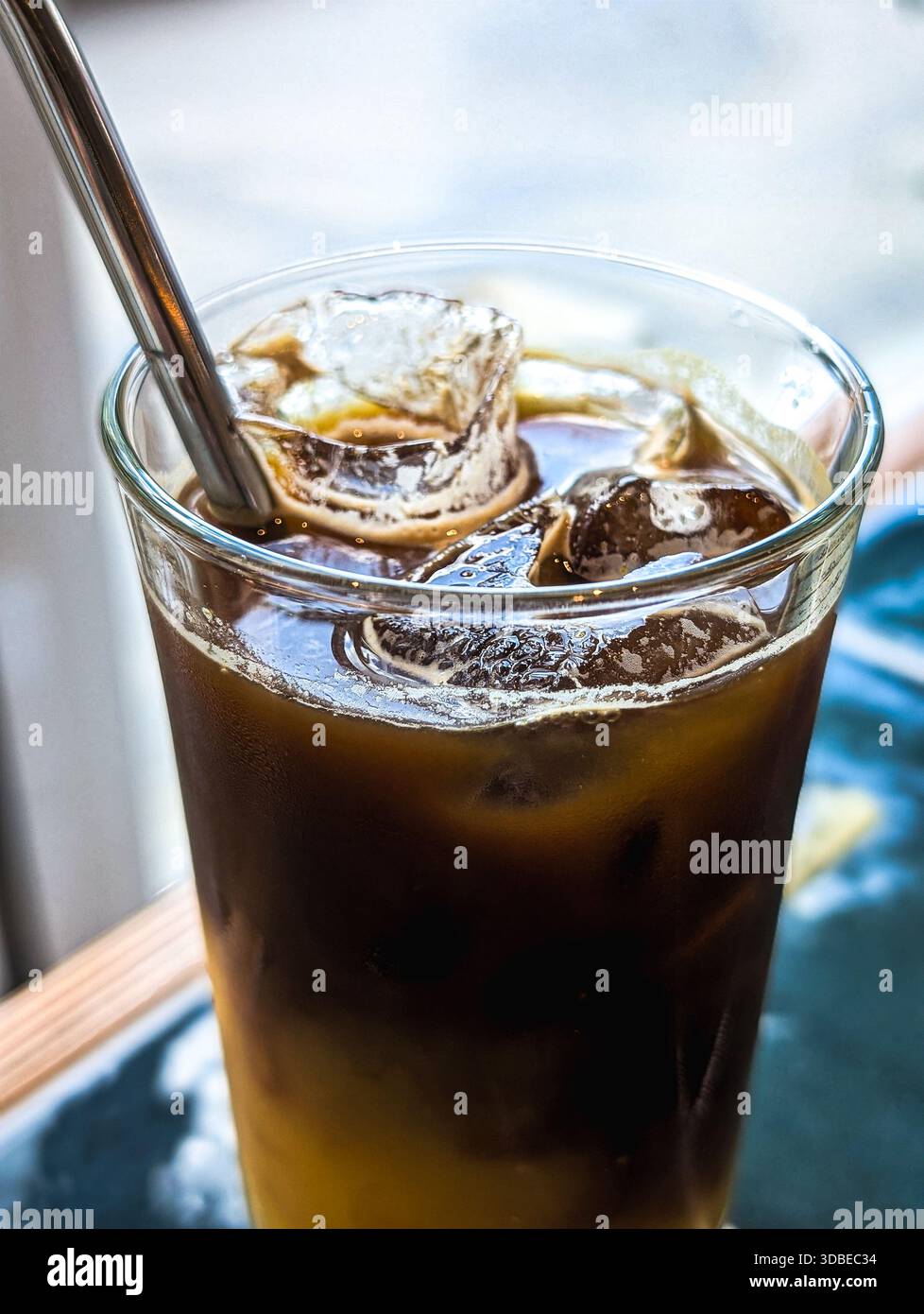 Erfrischender Eiskaffee mit Orangensaft im Glas Stockfoto