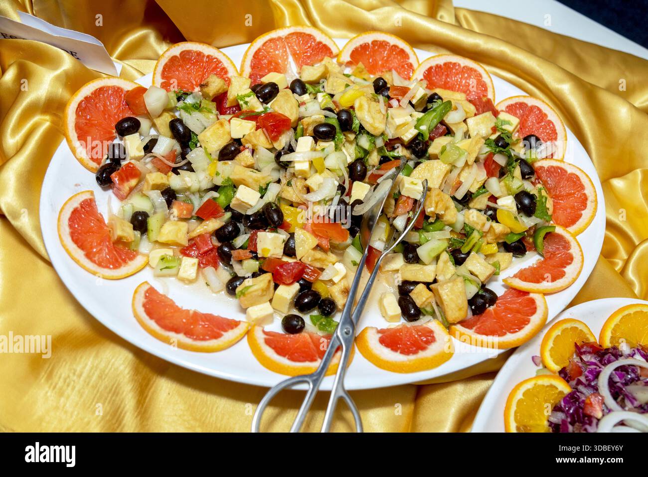 Frischer mediterraner Salat mit Grapefruit und Oliven, serviert auf einer Platte Stockfoto