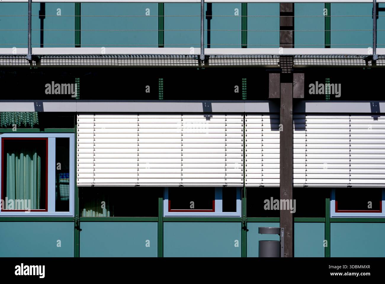 Rhythmen der Governance: Eine Studie zu Kontrast und Ordnung. Fassade des Bezirksbüros Starnberg mit strukturierten Fenstern und weißen Rollläden, entworfen von Auer Weber Architects. Stockfoto