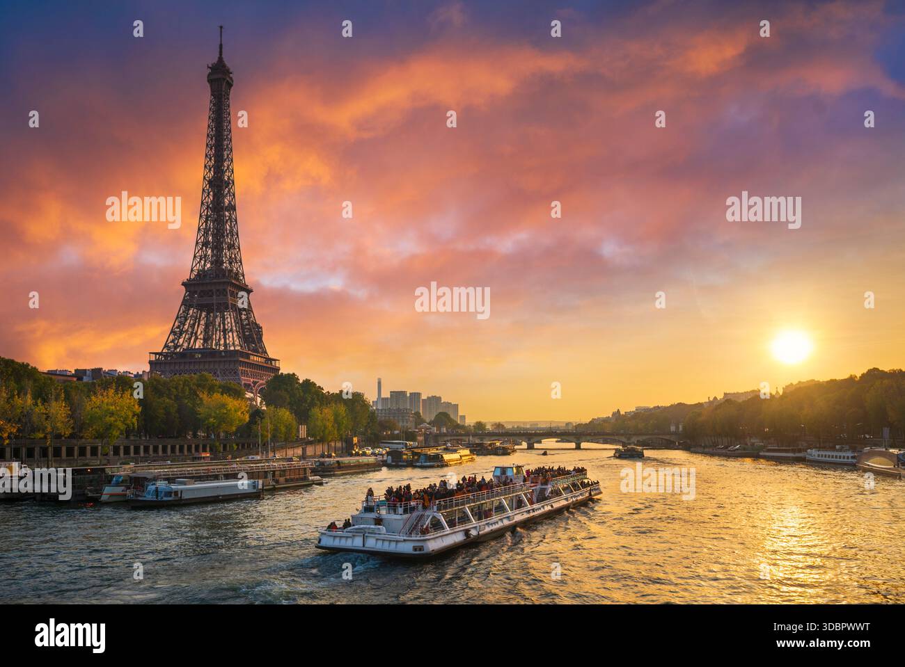 Sonnenuntergang am Eiffelturm, Paris, Frankreich mit einem Touristenboot Stockfoto