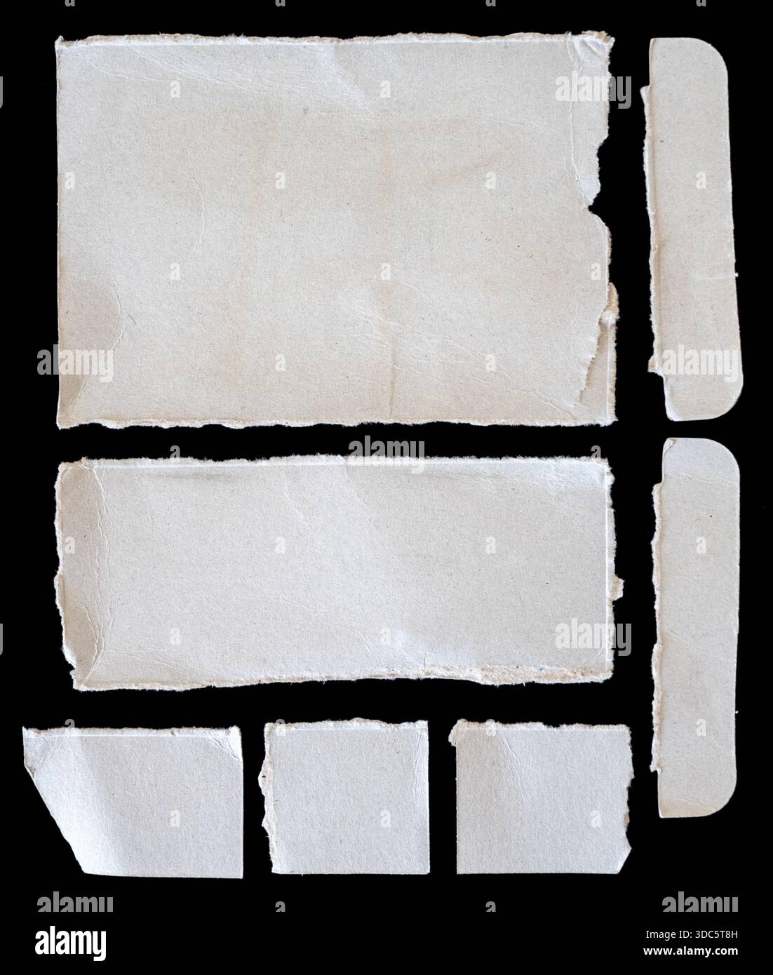 Zerrissene Papierstücke auf schwarzem Hintergrund Stockfoto