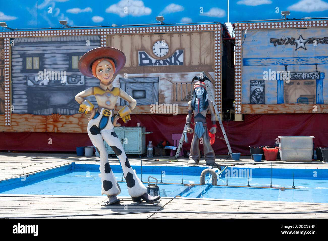 Jerez, Spanien - 5. Mai 23: Eine bunte Outdoor-Szene mit Zeichentrickfiguren in westlicher Umgebung. Ein Cowgirl mit Cowboyhut und gepunktetem Outfit Stockfoto