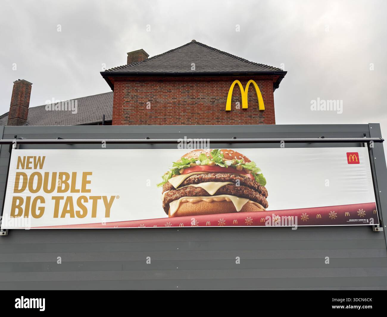 London, England – McDonald's Restaurant zeigt Werbeplakat New Double Big Tasty Burger mit goldenen Bögen-Logo und Fast-Food-Werbung Stockfoto