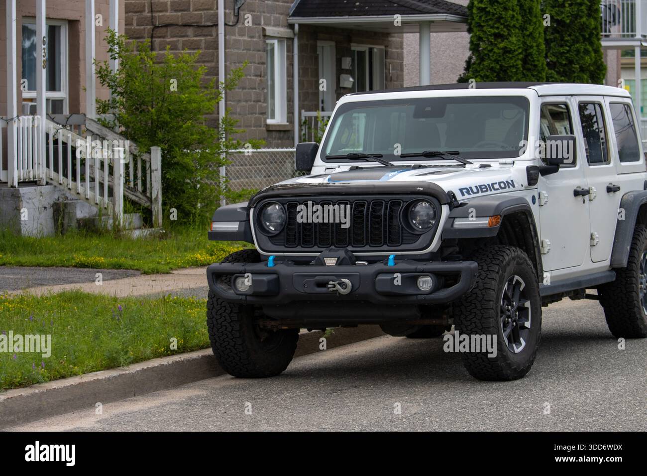 Kanada, Québec, 13. Juli 2025 : Weißer Geländewagen parkt auf einer Wohnstraße neben dem alten Haus Stockfoto