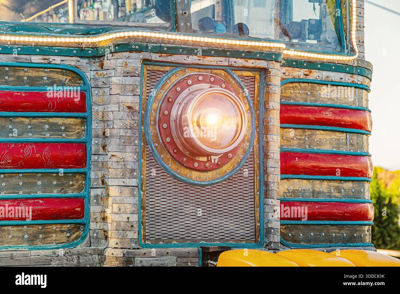 Aufwändige Maschinenfassade im Steampunk-Stil mit markanter Linse, rustikalen Holzdielen, Metalldetails und roten Akzenten Stockfoto