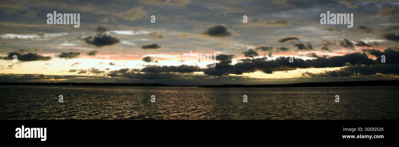 Der kalte Winteruntergang auf der Westseite von Hilton Head Island, South Carolina, spiegelt sich hinter den Wolken über dem Calibogue Sound wider. Stockfoto