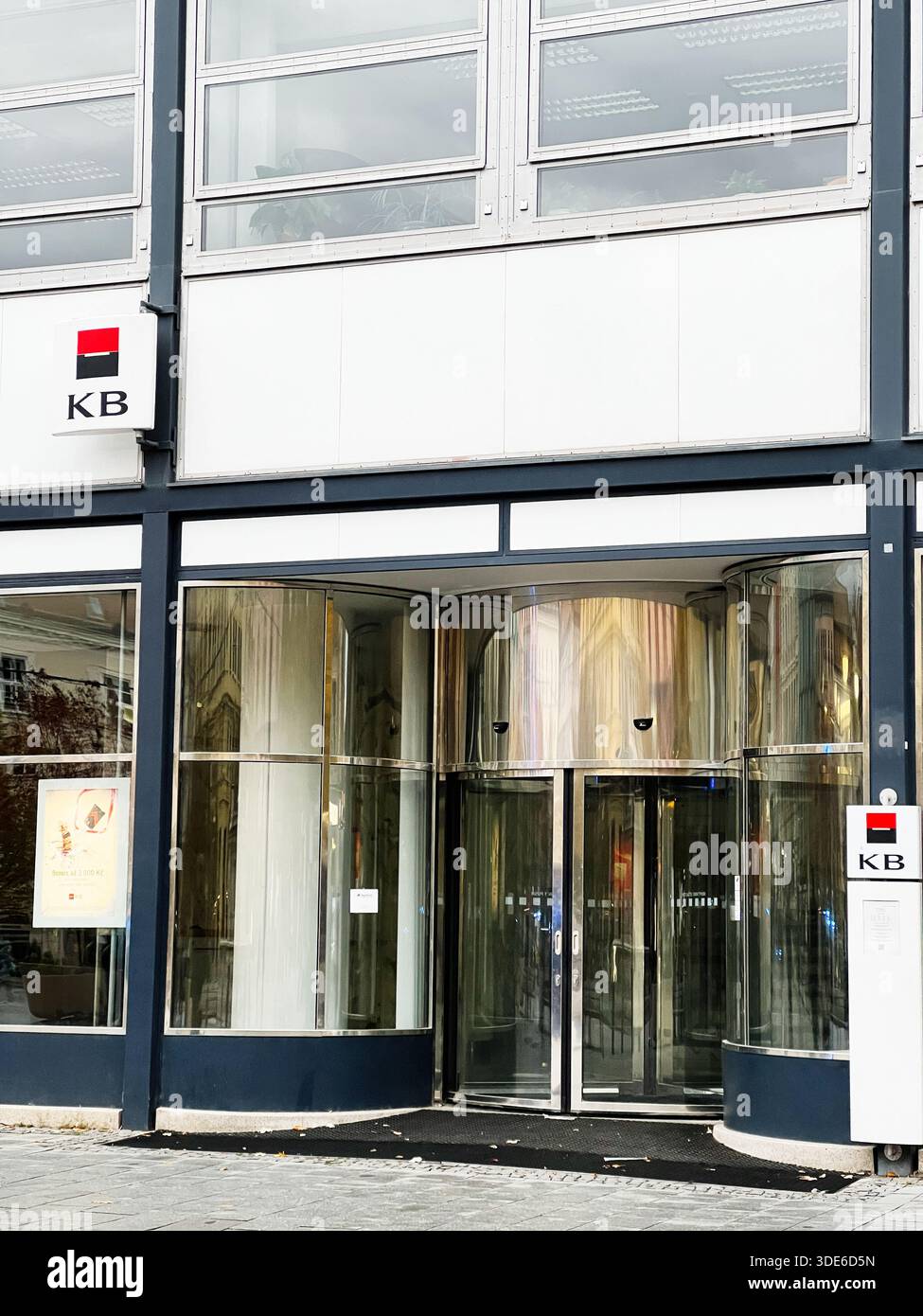 Brünn, Tschechische Republik - 29. November 2025: Ein moderner Firmeneingang mit drehbaren Glastüren und einem KB-Bankschild. Stockfoto