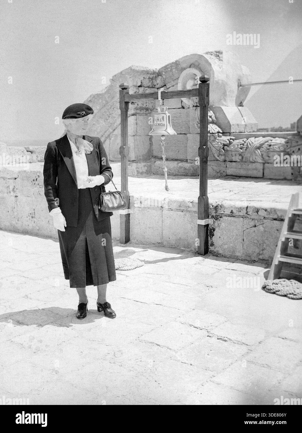 Britische Frau, vermutlich die Ehefrau eines Offiziers der Royal Navy, stehend neben der Schiffsglocke der HMS Phoenicia Uferstation, Manoel Island, Malta, Europa, 1957 Stockfoto
