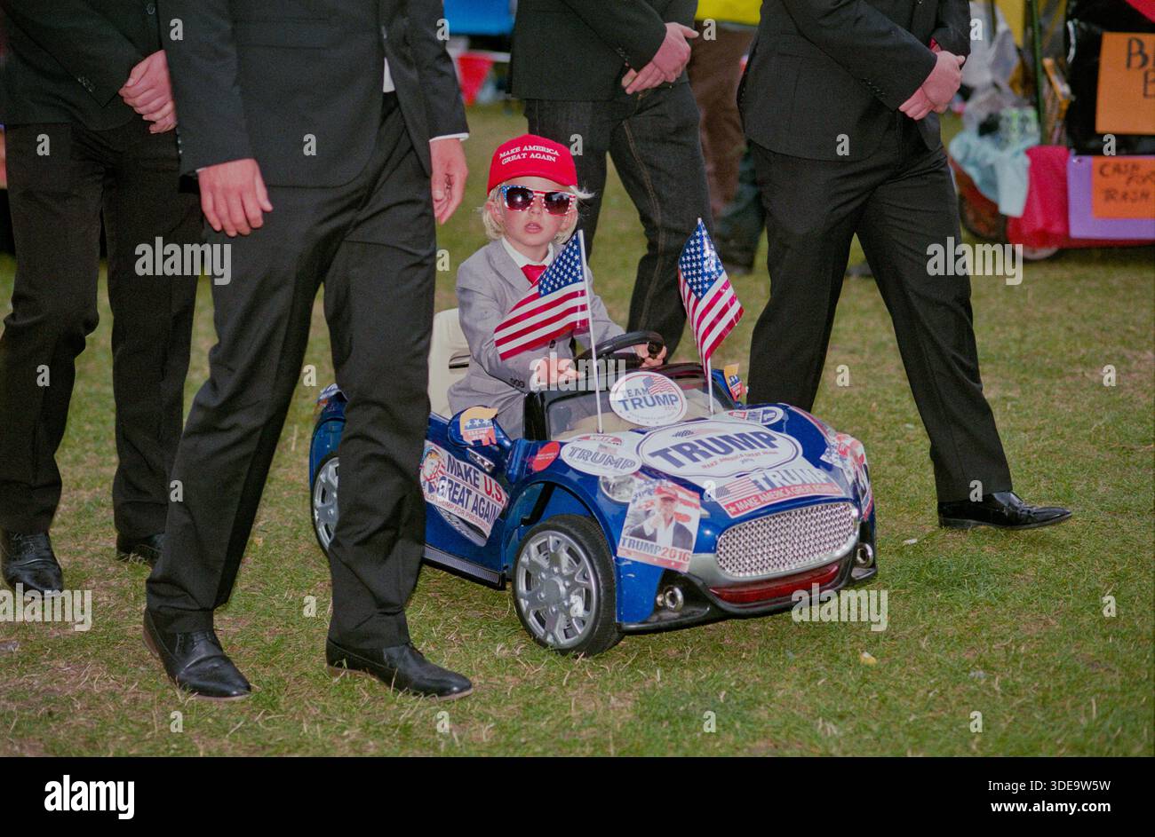 "Donald Trump" und die Leibwächter sind beim Wells Next the Sea Karneval in Norfolk dabei. Stockfoto
