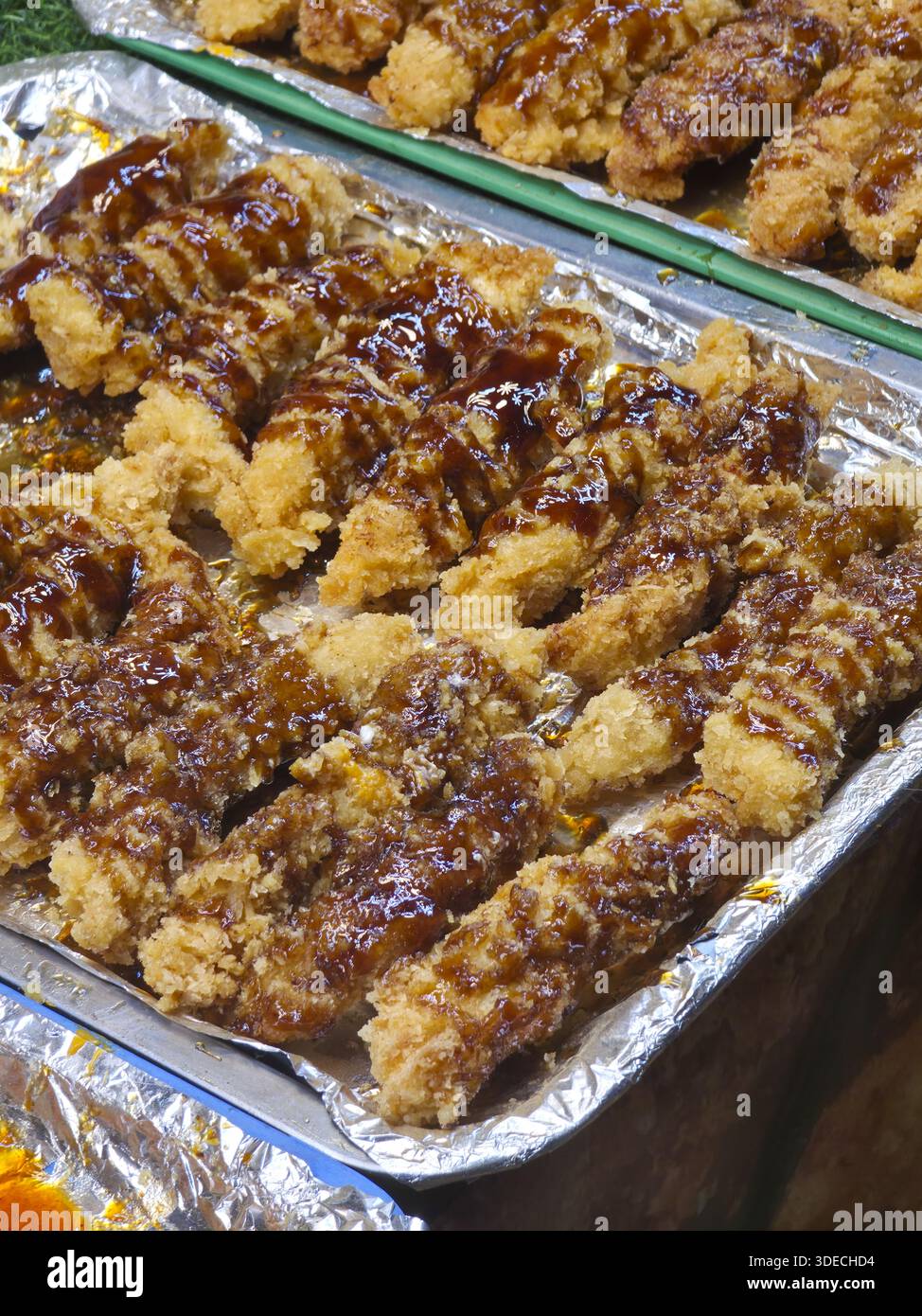 Knusprig gebratener Teig-Stick-Gebäck-Snack mit süßer Schokoladensoße auf glänzendem Metalltablett zum Dessertverkauf am lokalen Street Food Market Stand l Stockfoto