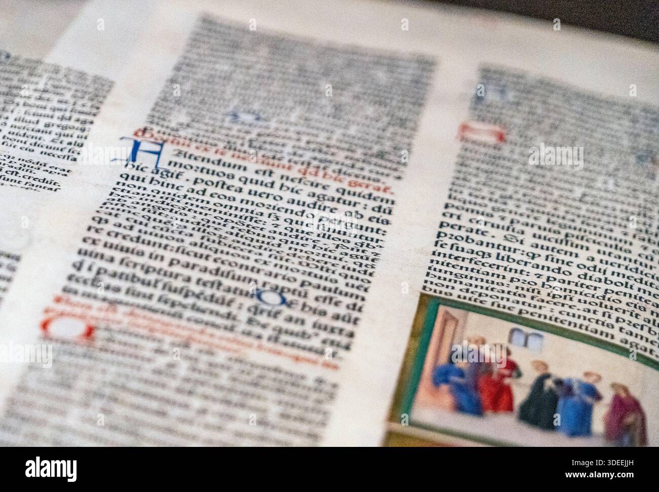 Nahaufnahme von alten Manuskriptseiten mit handgeschriebenem Text und farbenfrohen Illustrationen Stockfoto
