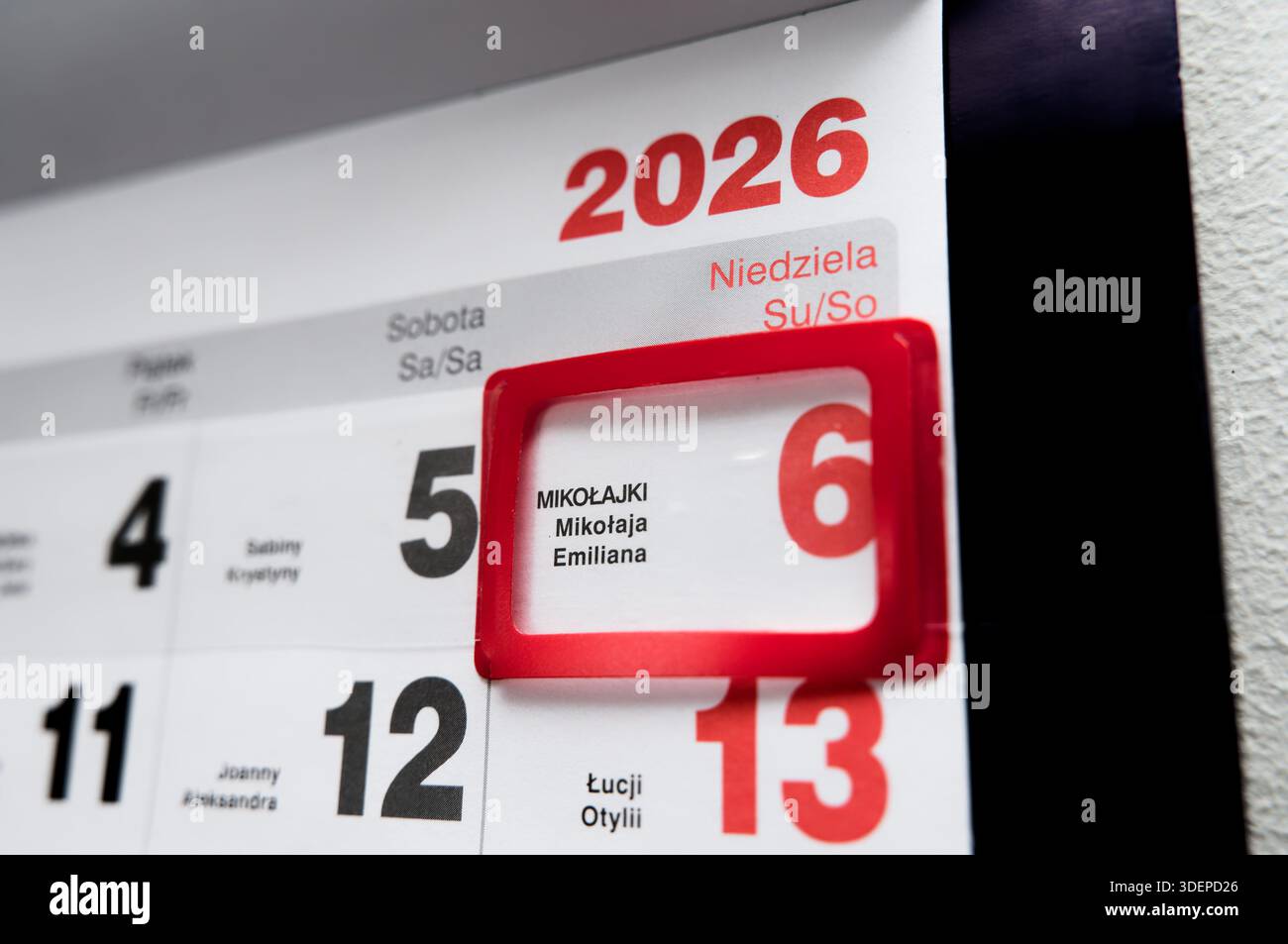 2026 Wandkalender in Nahaufnahme mit rotem Rahmen, der den Nikolaustag, die polnische Tradition und die Winterferien hervorhebt. Stockfoto