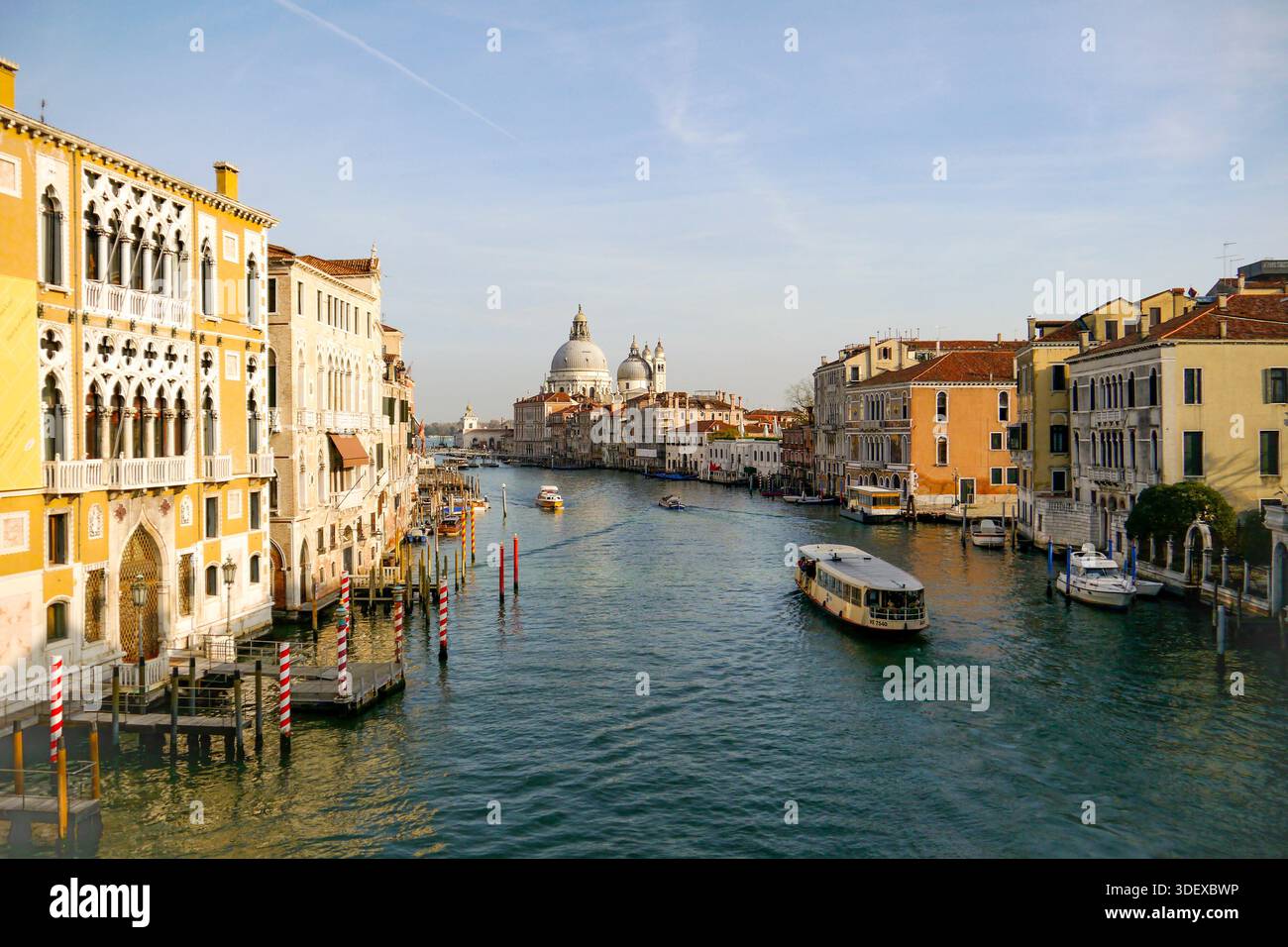 Basilika Santa Maria della Salute der Canal Grande in Venedig, Italien, die wichtigste Wasserstraße der Stadt, gesäumt von historischen Palästen und mit Booten, die die ikonische Architektur und das tägliche Leben der Lagunenstadt Venedig, Italien, eine historische Stadt, die auf Kanälen und Inseln in der Lagune erbaut wurde und für ihre Architektur, Wasserstraßen und zeitloses Kulturerbe bekannt ist. Stockfoto