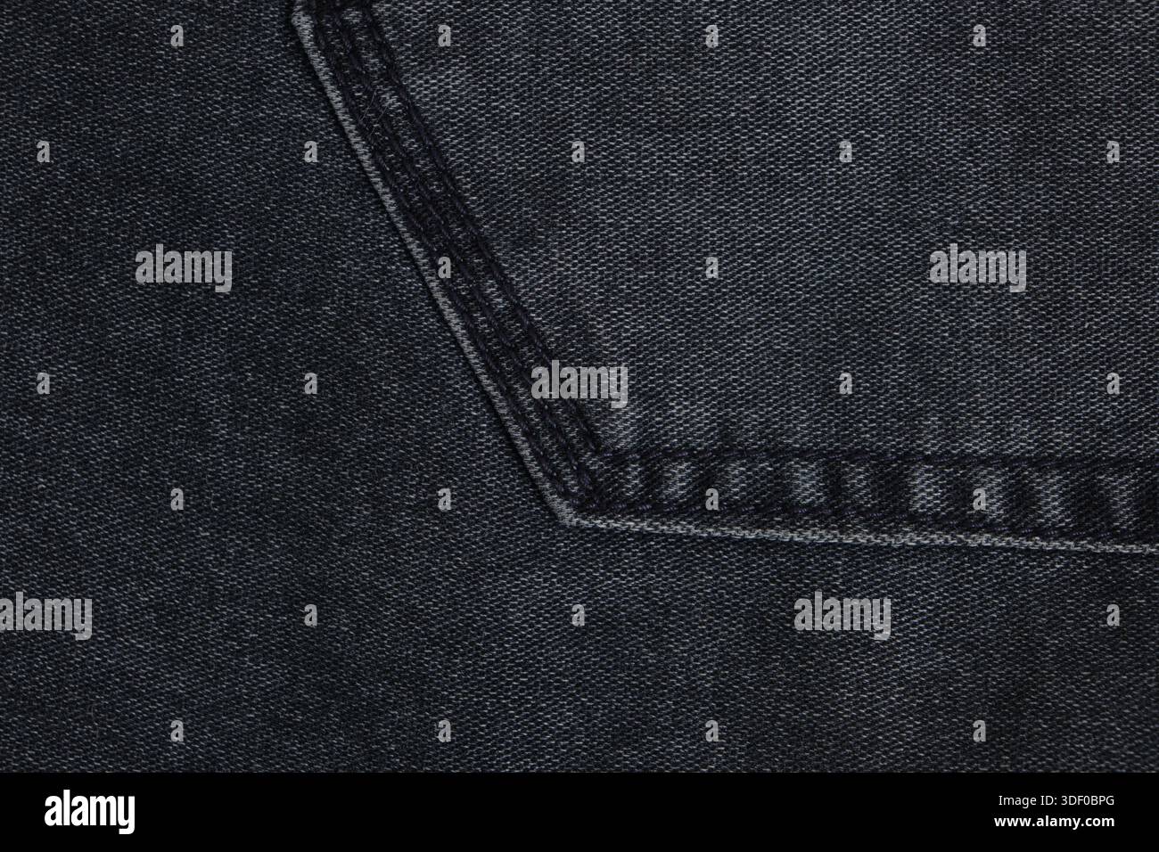 Dunkelgrauer Hintergrund oder Textur aus Denim mit Naht Stockfoto