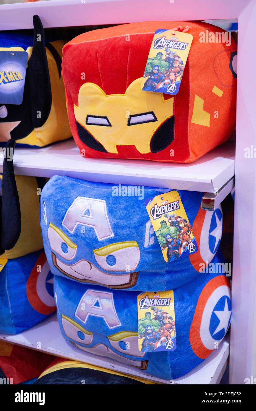 Nahaufnahme der Plüschkissen von Marvel Avengers mit Iron man und Captain America, die lizenzierte Werbeartikel in den Regalen des Stores hervorheben. Stockfoto
