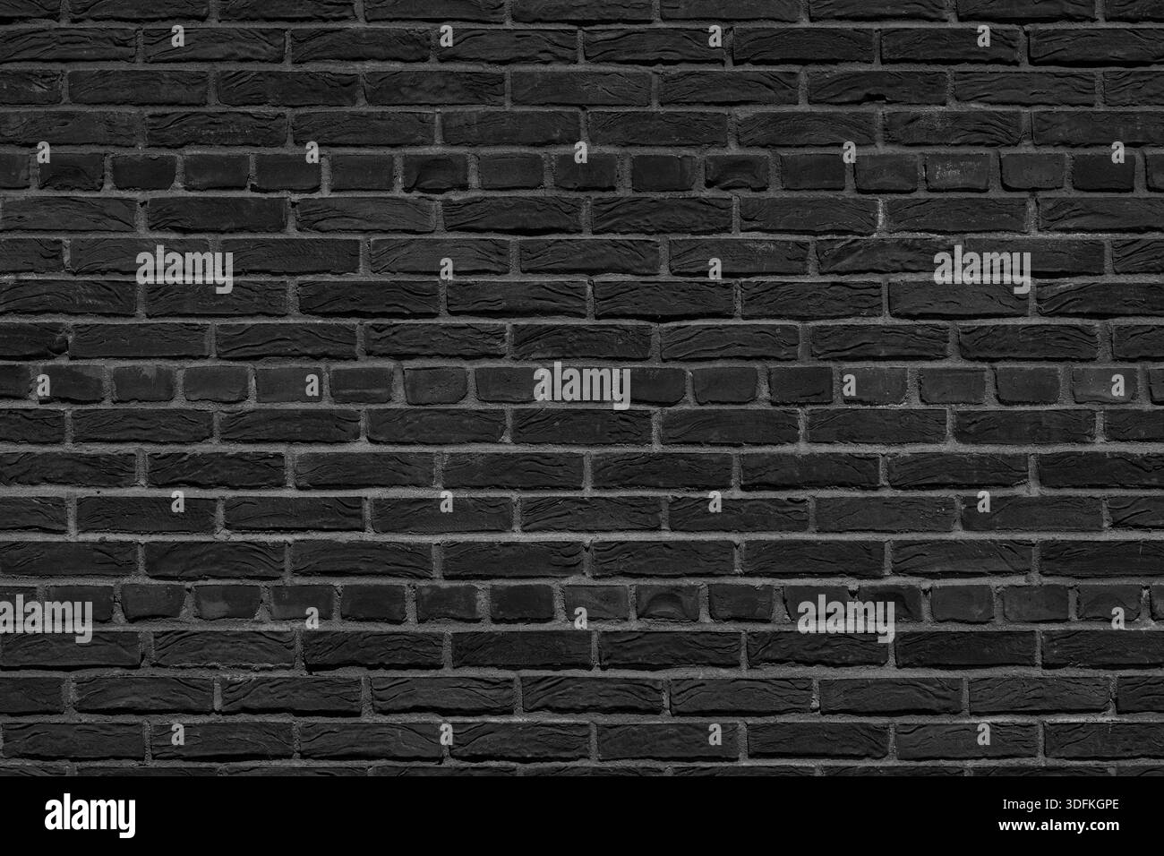 Alte schwarze Ziegelmauer. Abstrakter Innenhintergrund. Stockfoto