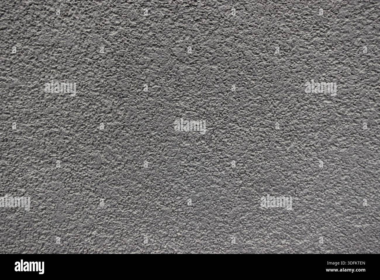 Nahaufnahme einer grauen Betonwand mit rauer Textur, geeignet als abstrakter architektonischer Hintergrund Stockfoto