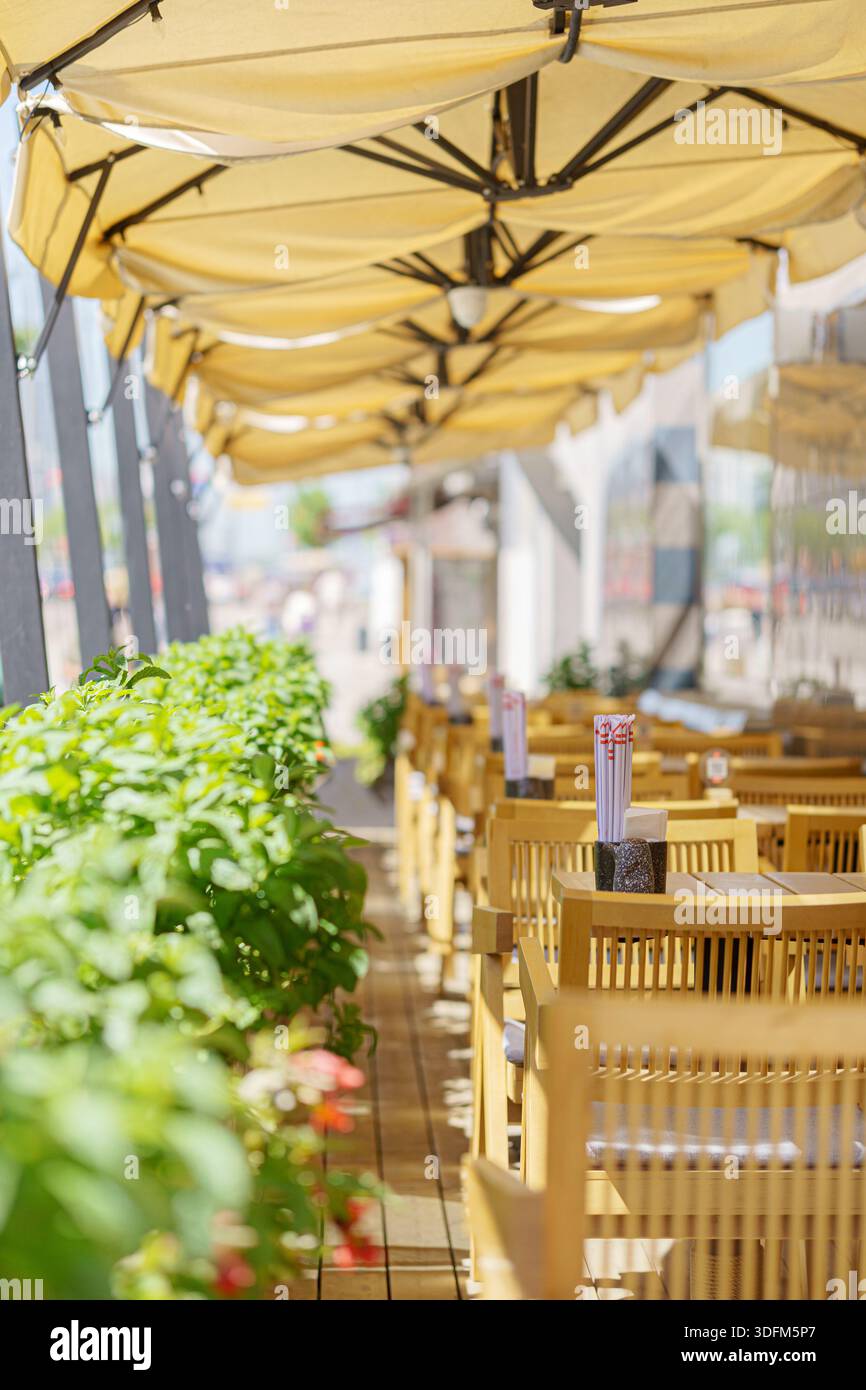 Sonniger Tag in einem Sommercafé im Schatten eines Baldachins. Stockfoto