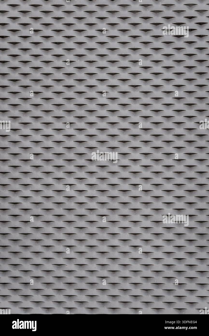Grau-schwarz gemusterte Oberfläche. Das Muster besteht aus kleinen Dreiecken. Stockfoto