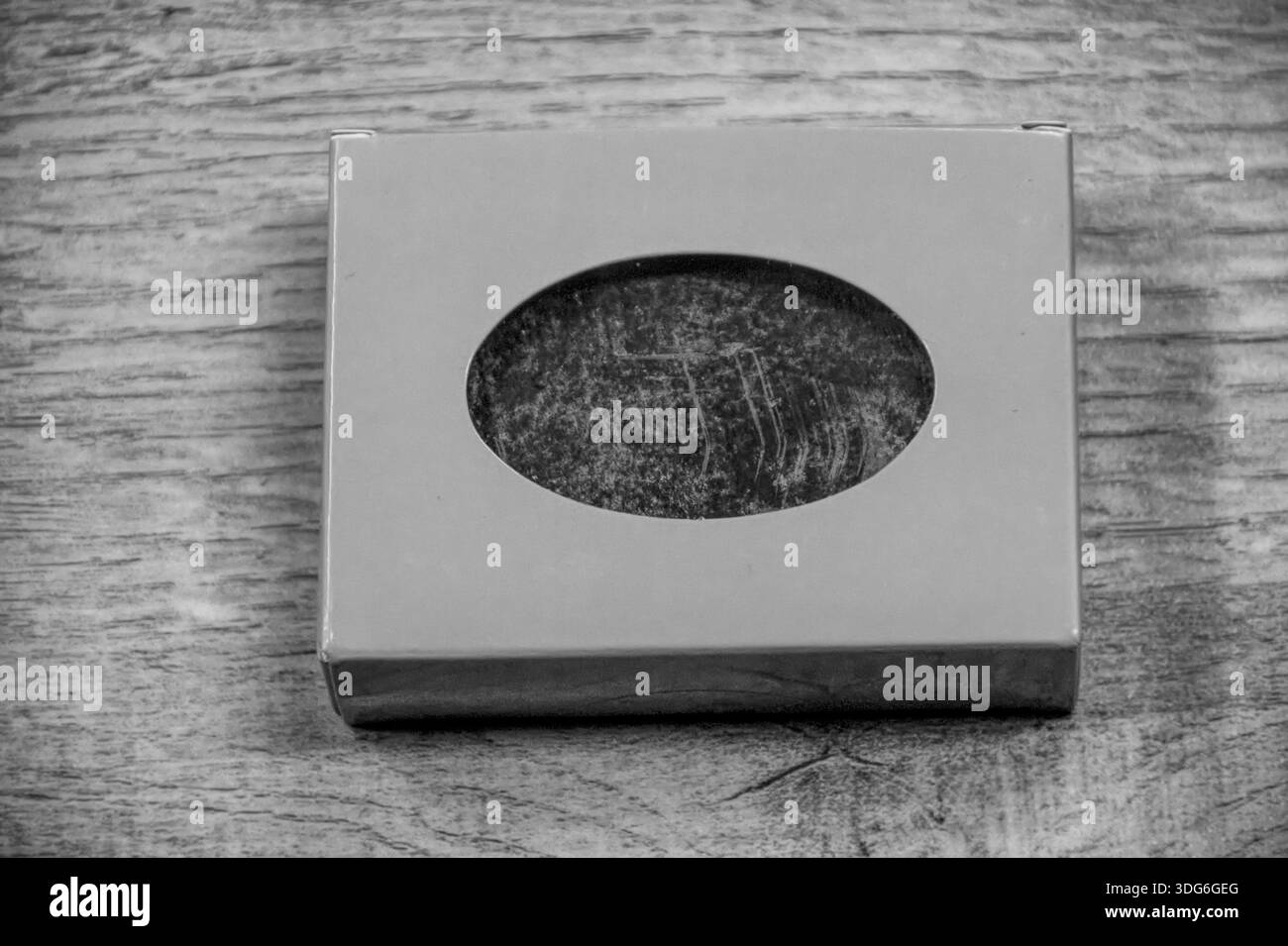 Schwarz-weiß-Foto von einer kleinen rosafarbenen Box mit Seife Stockfoto